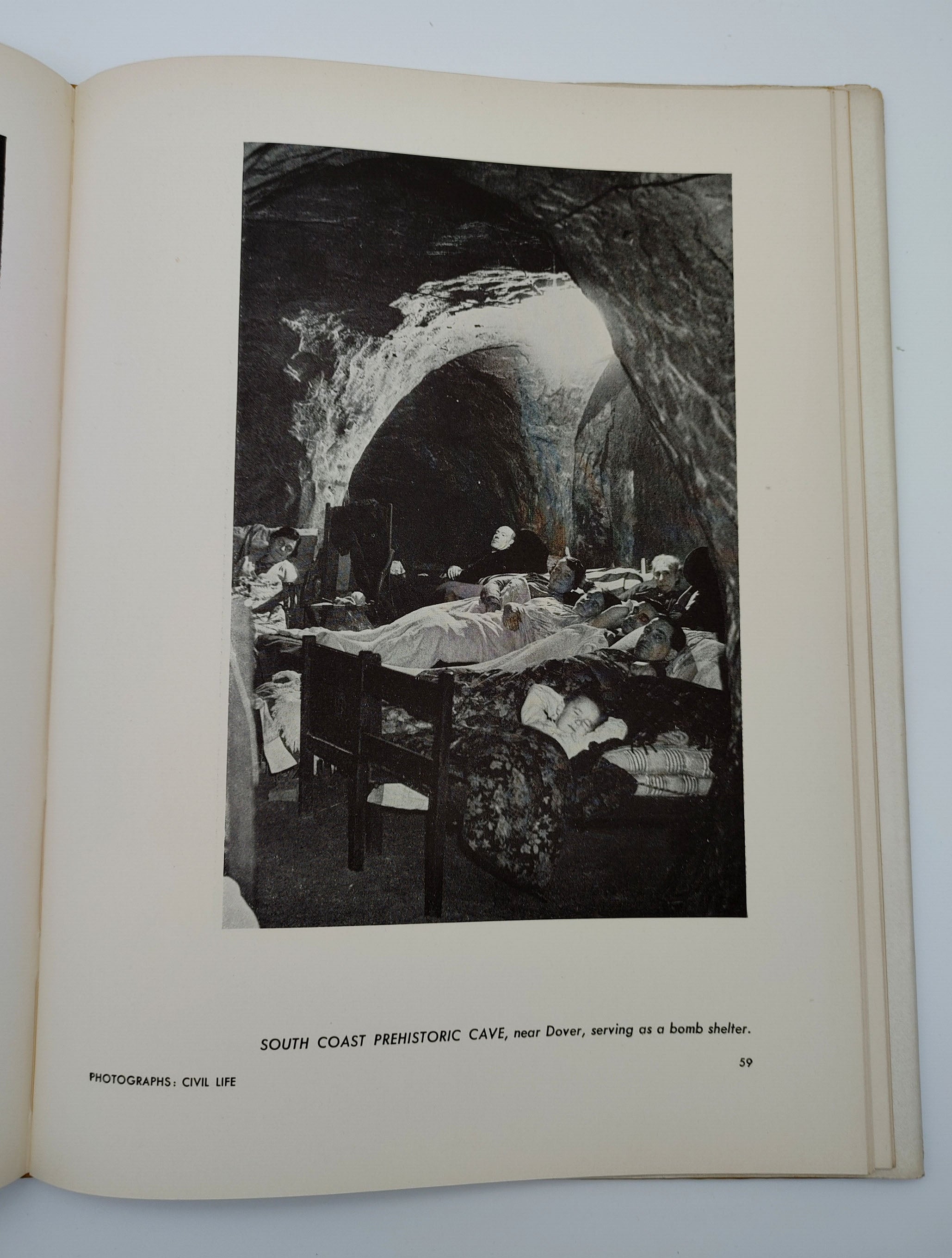 A picture of an air raid shelter in a British prehistoric cave from the first edition of the Museum of Modern Art's Britain at War (1941)