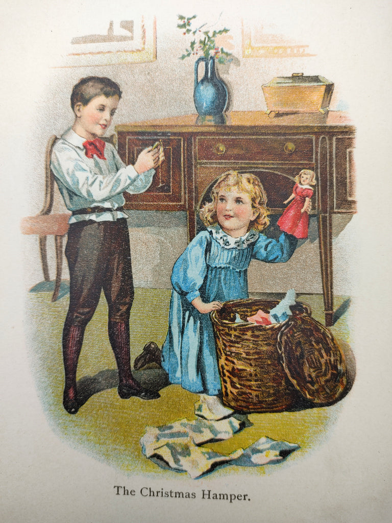 Illustration of two Edwardian children with a Christmas hamper from the first edition of The Christmas Hamper (1906)