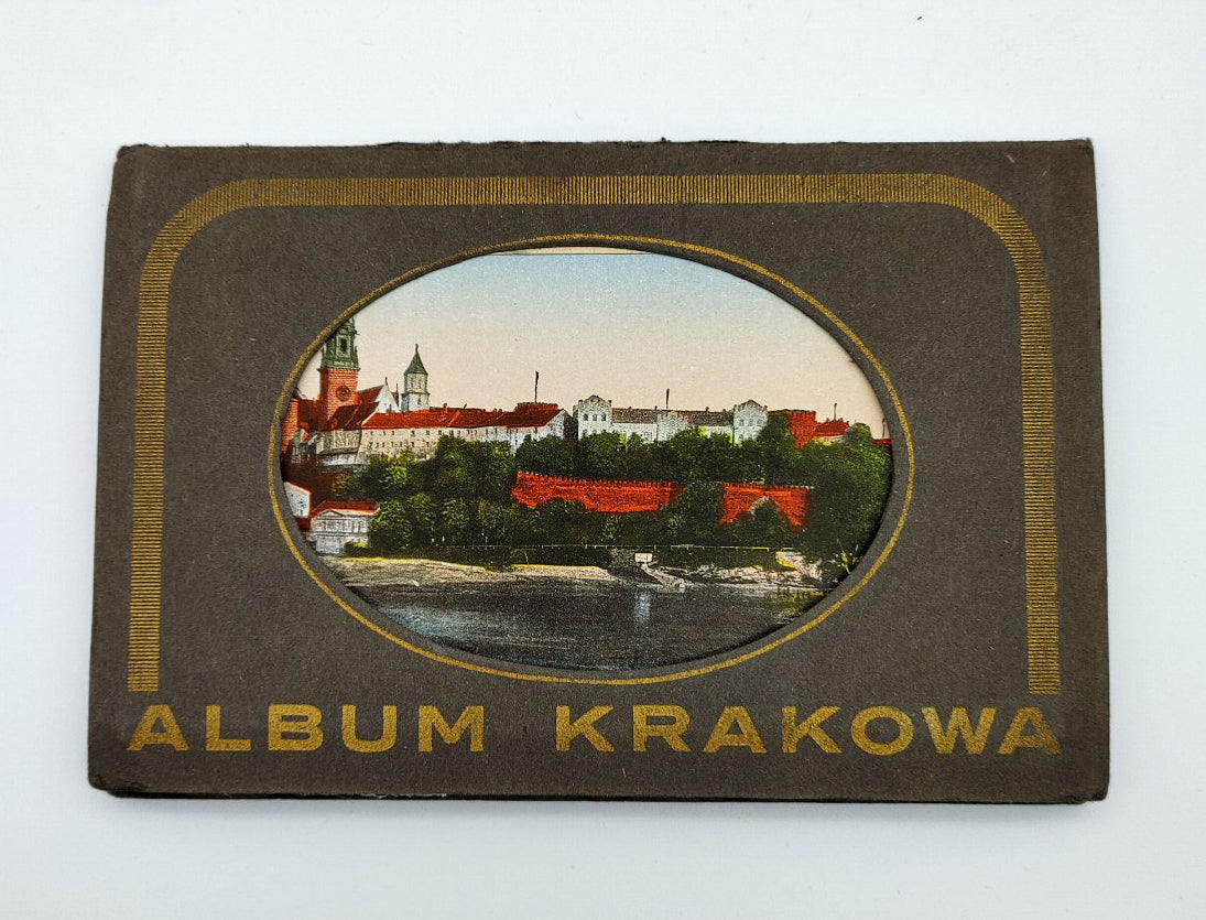 Cover of the rare 1920s book Album Krakowa featuring a cut out with a color image of Krakow showing through