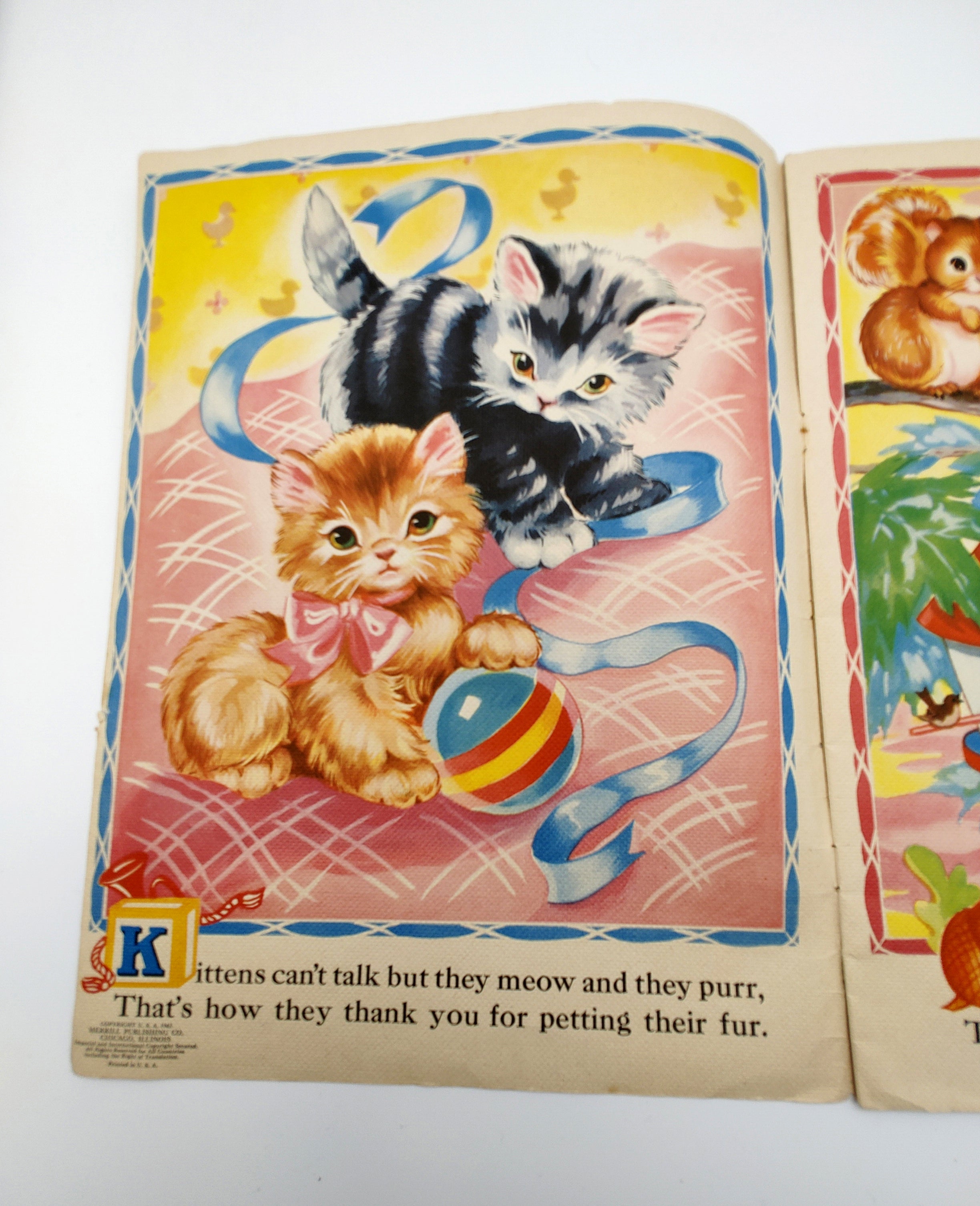 Illustration of two kittens with a ribbon and a ball fromAnimal Pictures and Rhymes (1943)