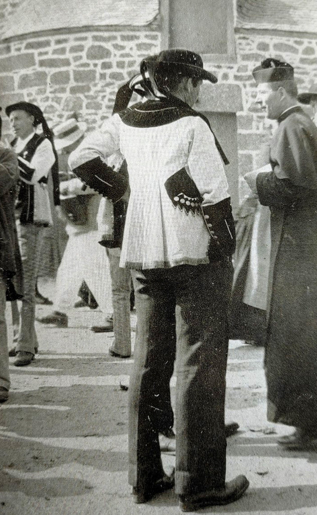 Photograph of a men in traditional Brittany, France clothing talking to a priest from A Vagabond Voyage Through Brittany (1915)